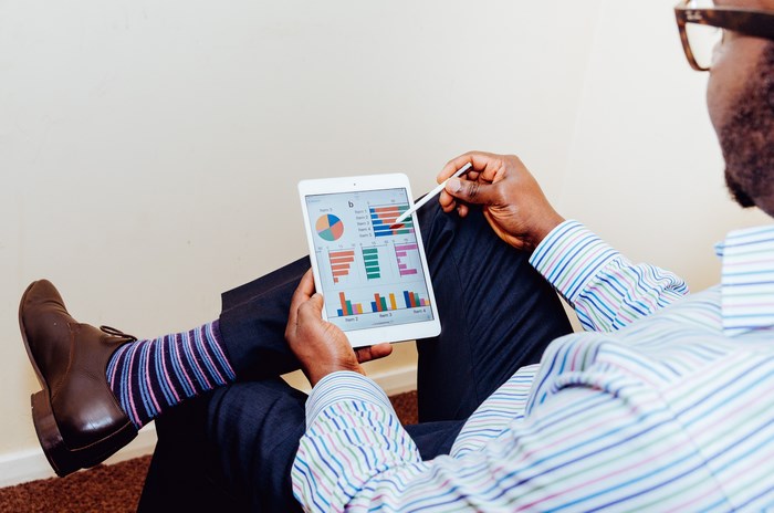 Man reviewing charts on a tablet