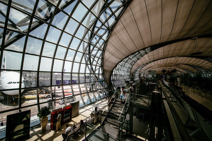 Modern airport interior with airplane at gate