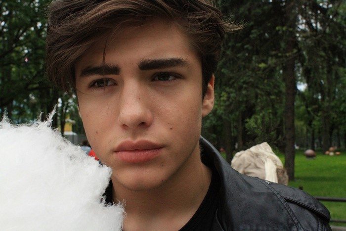 Boy with cotton candy in a park
