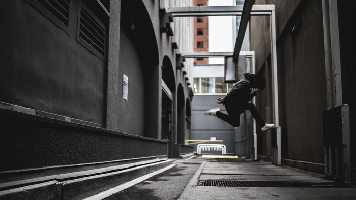 Person jumping in an urban alleyway in Calgary