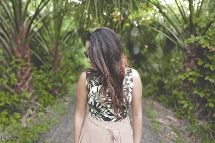 Woman in tropical clothing on a forest path