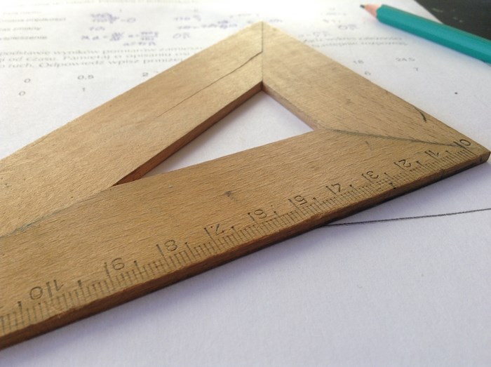 Wooden ruler on a math paper with a pencil