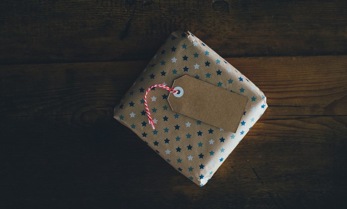 Gift wrapped with star pattern and gift tag on wood