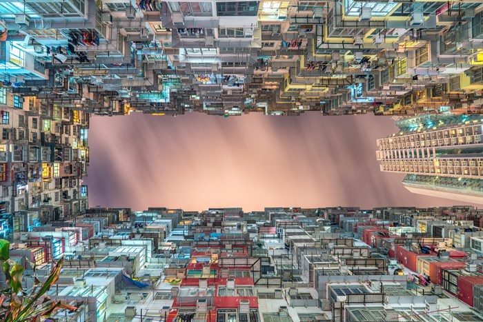 Hong Kong apartment buildings at night, looking up