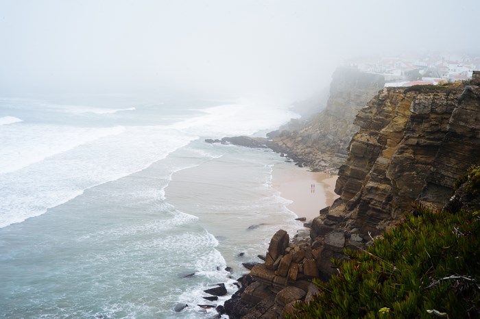 Foggy Coastline with Waves and Cliffs