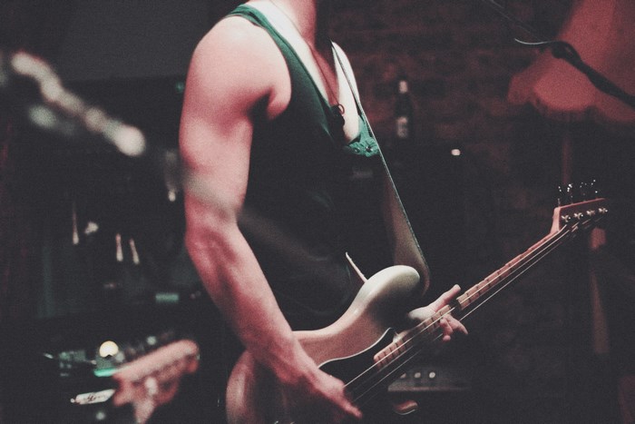 Man playing a bass guitar on stage