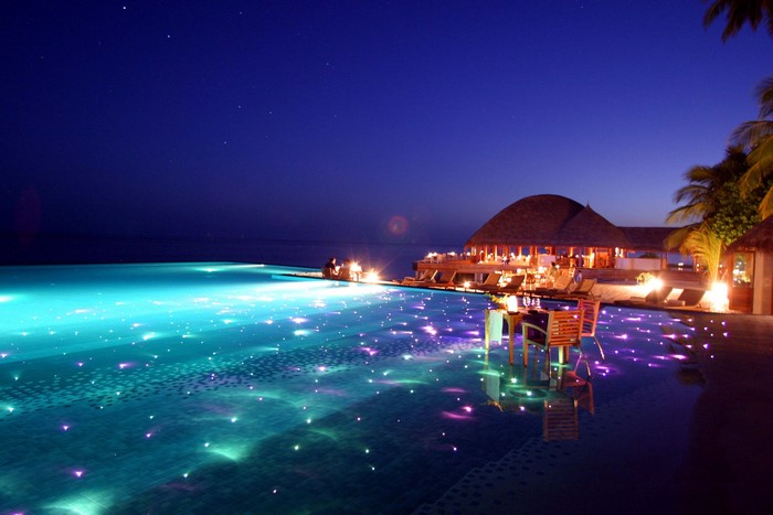 Infinity pool at a tropical resort at night