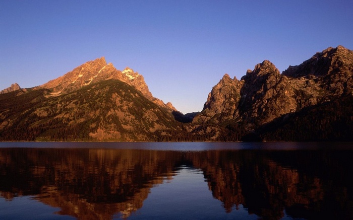 Mountains reflected in a lake at sunset