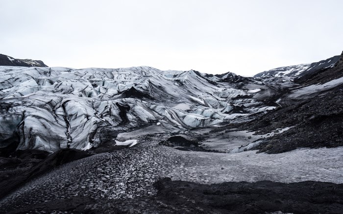 Glacier landscape in Iceland with black ash