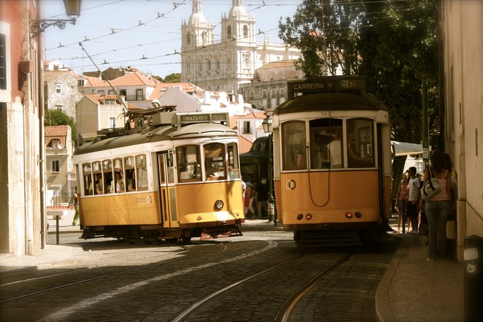 Lisbon Trams on Cobblestone Street with Church
