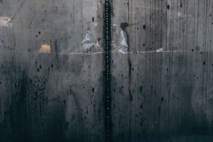 Concrete wall with weld and dirt texture