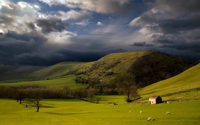 Stormy Sky Over Green Hills with Sheep and Barn