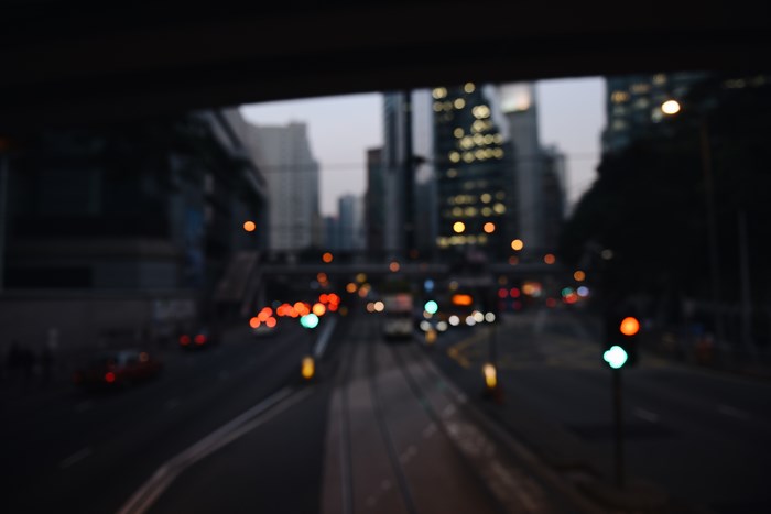 Blurred cityscape at dusk with traffic lights