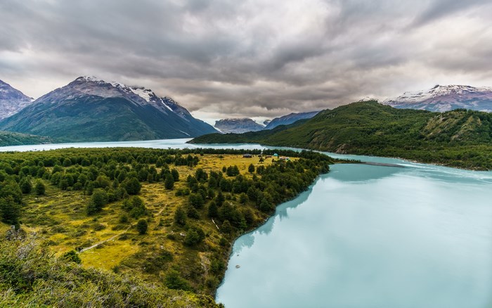 Mountain lake with forest and cloudy sky