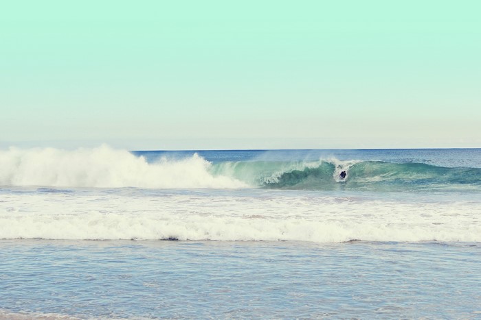 Surfer riding a wave in the ocean
