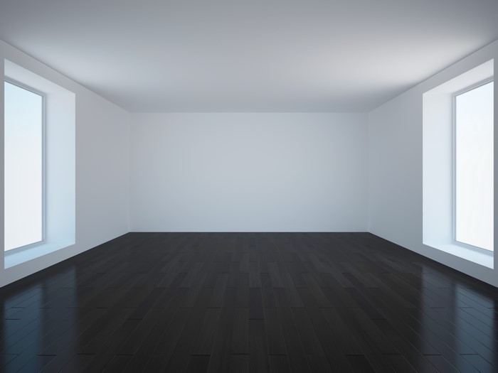 Empty room with dark wood floor and large windows