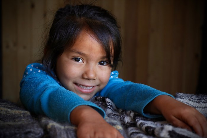 Young Pehuenche girl smiling in Icalma, Chile