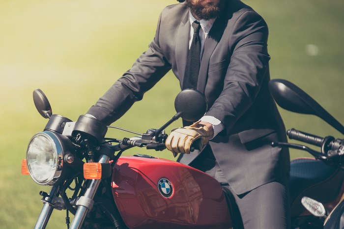 Man in Suit Riding a BMW Motorcycle