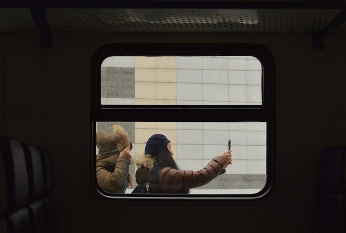 Two women taking a selfie on a train