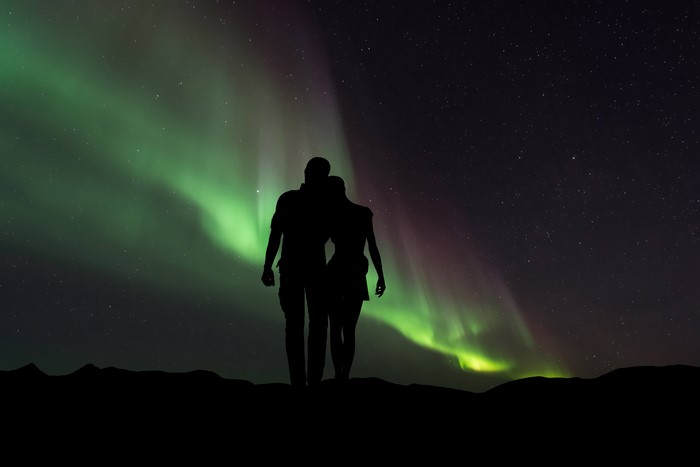 Couple watching the Aurora Borealis