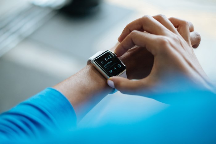 Person Checking Time on Apple Watch Digital Screen