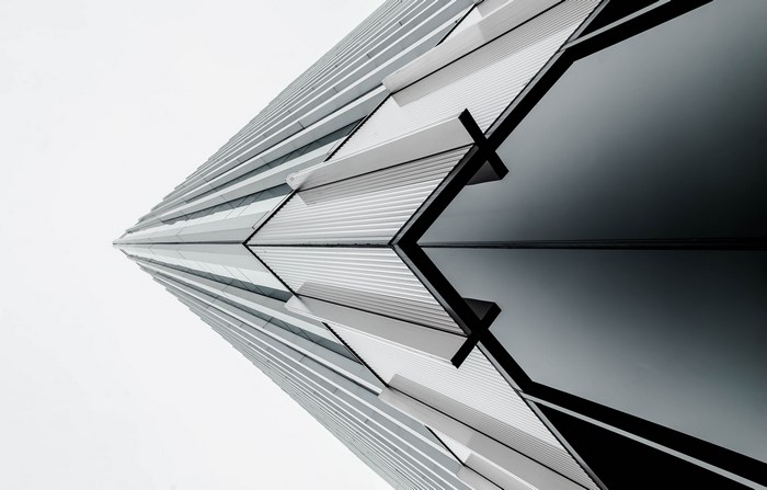 Modern building facade with geometric patterns and reflections