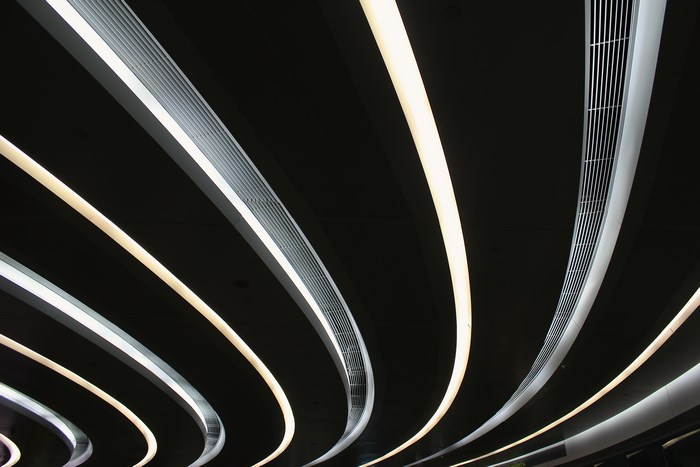 Abstract curved ceiling lights in a dark space