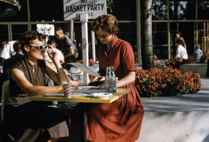 Two women at a cafe table with menus