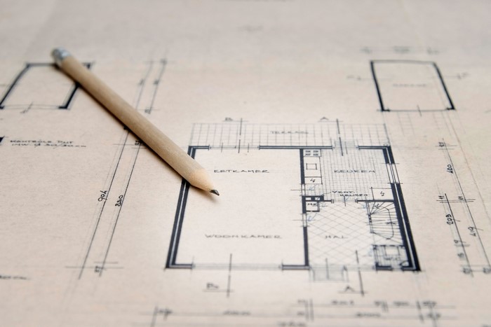 Architectural blueprint with a pencil