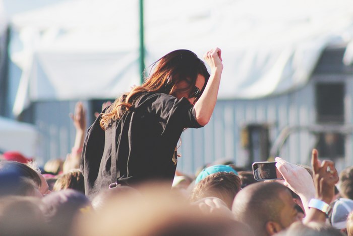 Woman dancing on shoulders at a summer festival