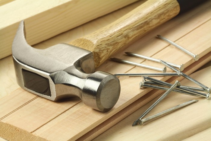Hammer and nails on wood planks
