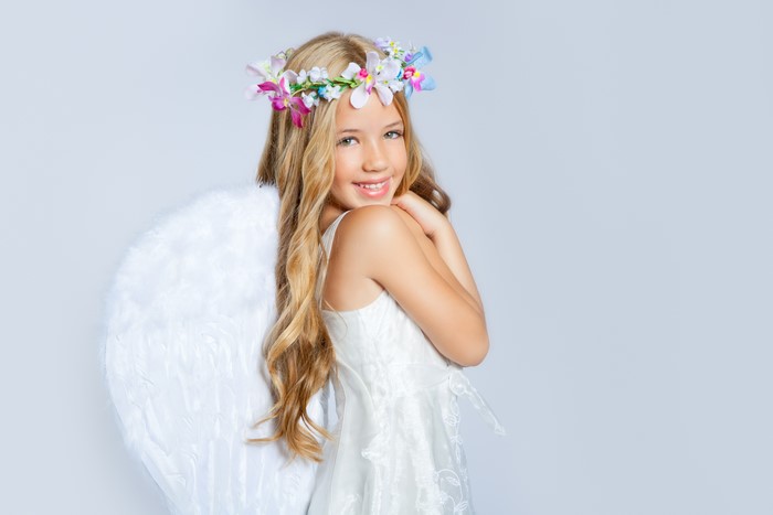 Girl dressed as an angel with a flower wreath