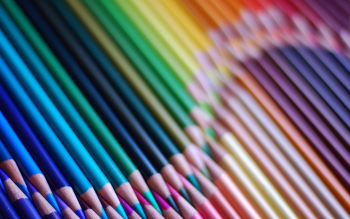 Colored pencils arranged in a rainbow spectrum
