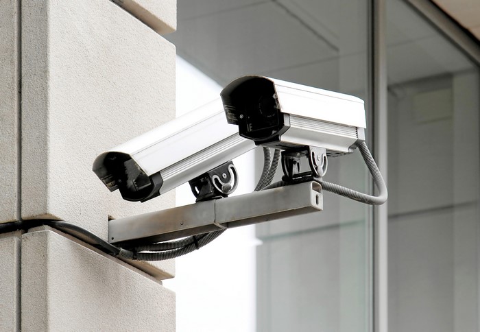 Two surveillance cameras mounted on a building exterior