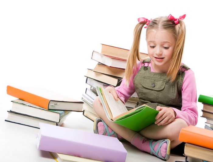 Young girl with pigtails reading books