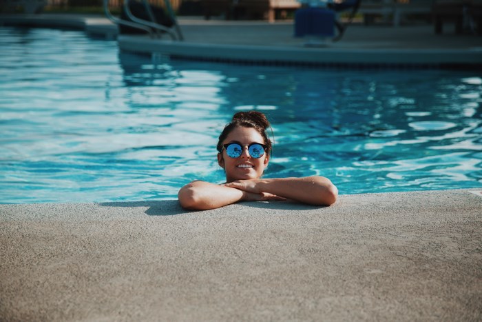 Woman in sunglasses relaxing in a swimming pool