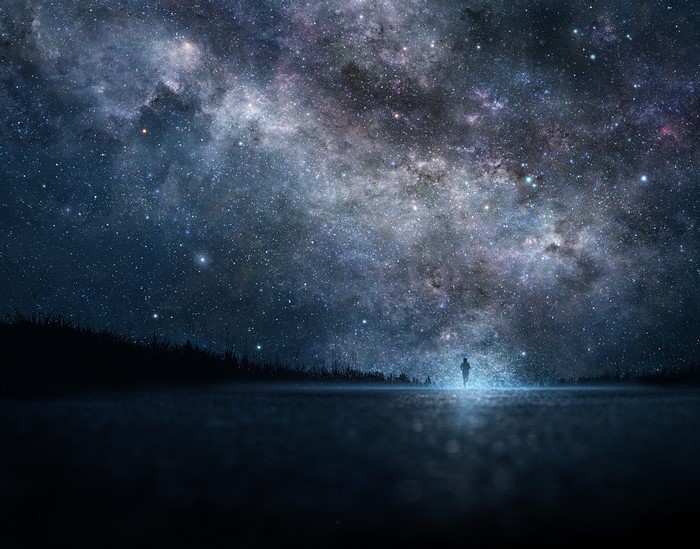 Silhouette of a person under the Milky Way