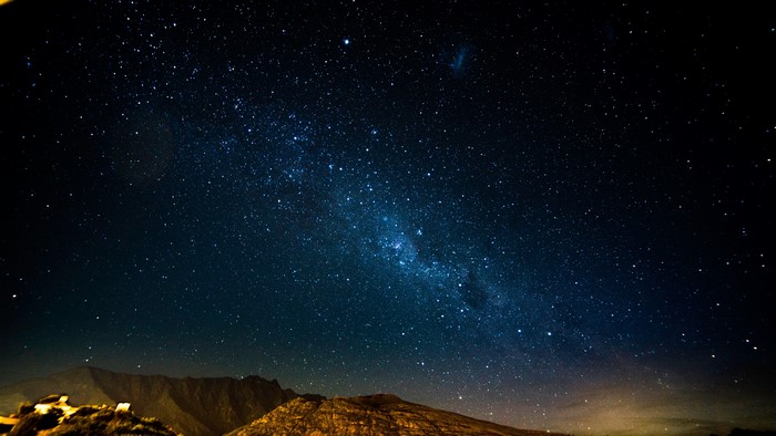 Starry night sky over mountains