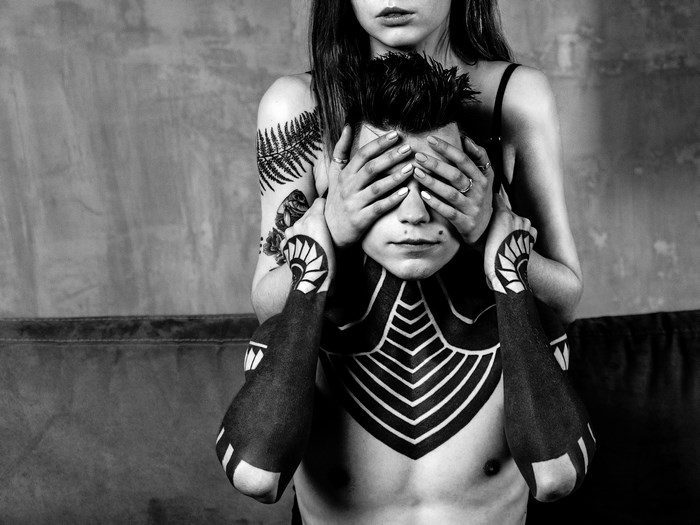 Couple with tattoos in a loft interior