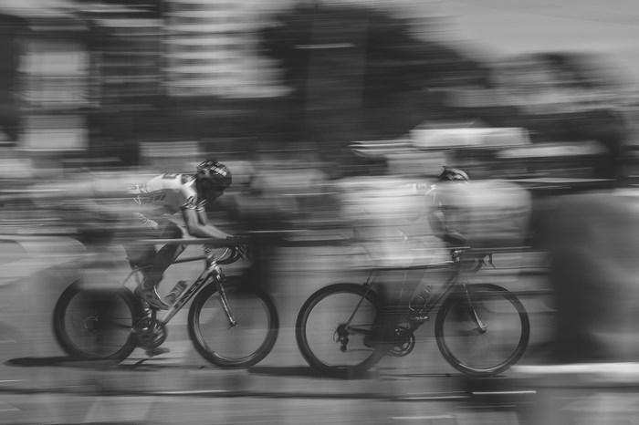 Cyclists racing in a monochrome competition