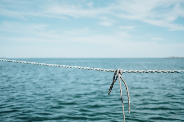 Rope tied in a knot over the sea