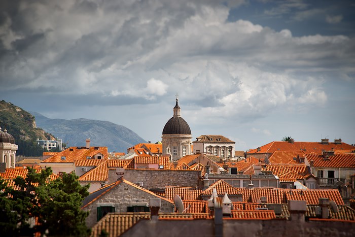 Dubrovnik cityscape with orange rooftops and a dome