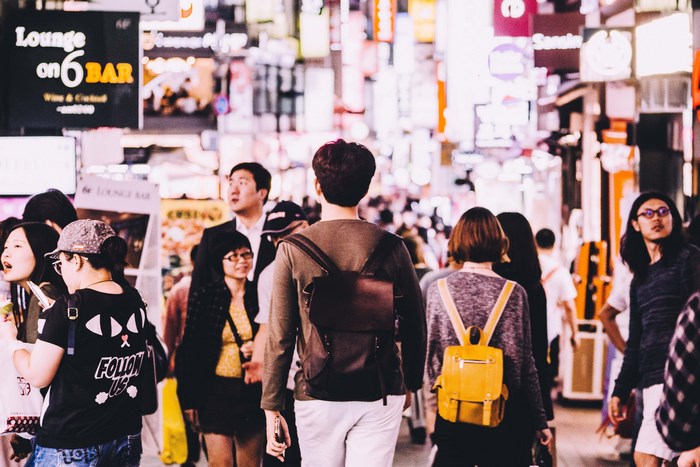 Crowded Seoul street with people and neon signs