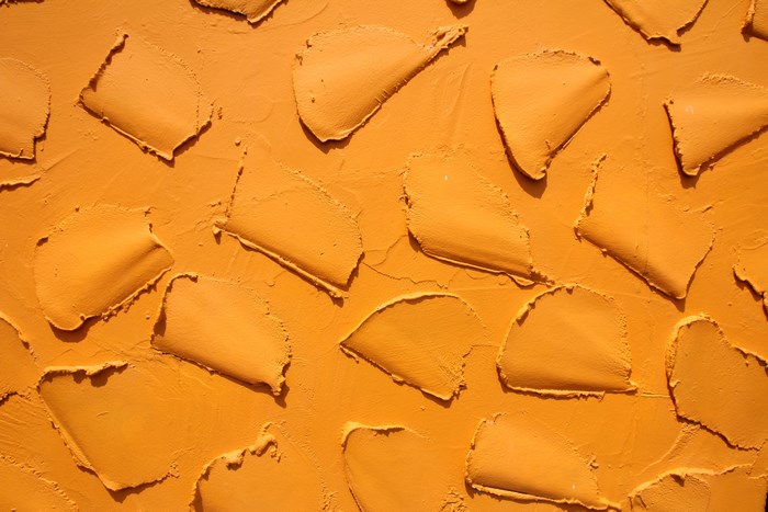 Orange textured plaster wall pattern
