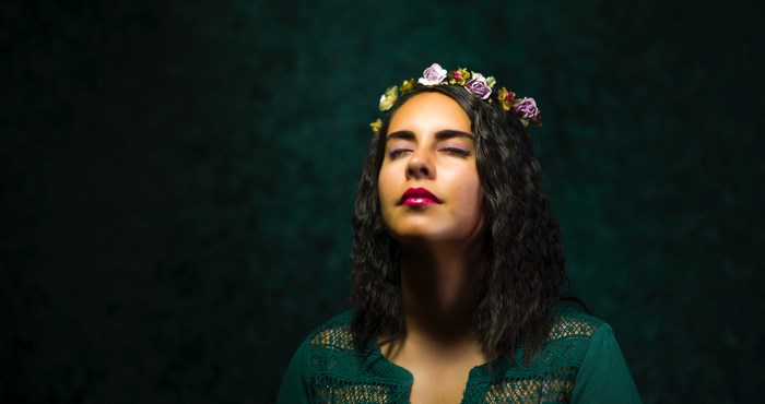 Woman with flower crown and green dress