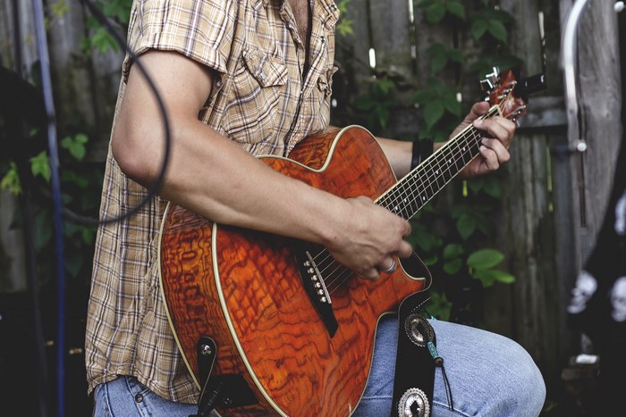 Man playing an acoustic guitar