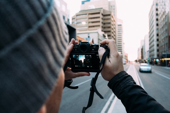 Photographer Capturing Urban City Street Scene