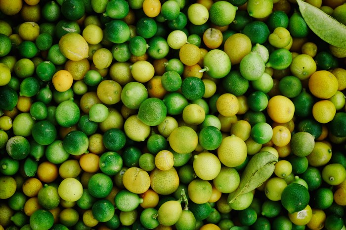 Pile of fresh green and yellow limes