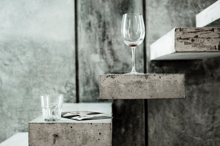 Wine glass and beaker on concrete steps
