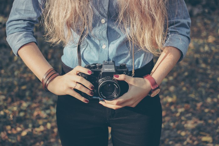 Woman holding a Zenith camera
